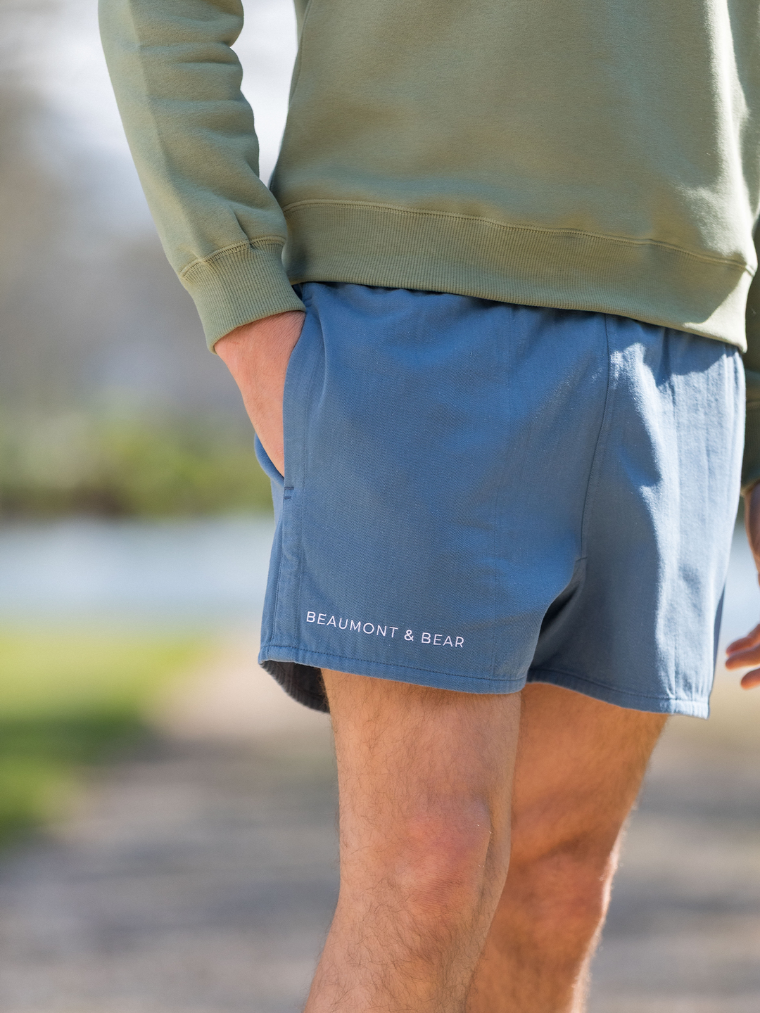 Men's vintage-style blue shorts featuring white embroidered Beaumont & Bear logo on lower right leg - classic summer fashion