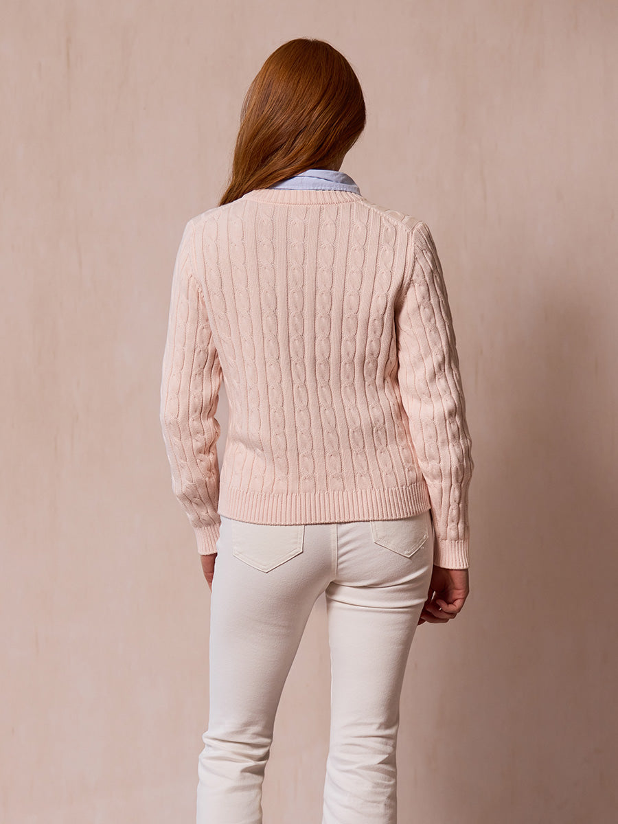 A woman modeling the Dusty pink cable-knit sweater from behind