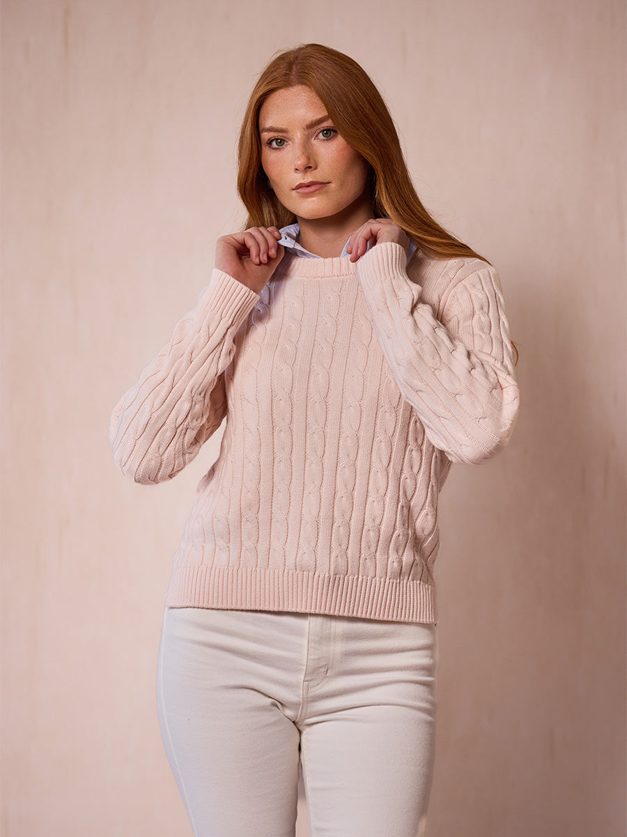 A woman modeling the Dusty pink cable-knit sweater